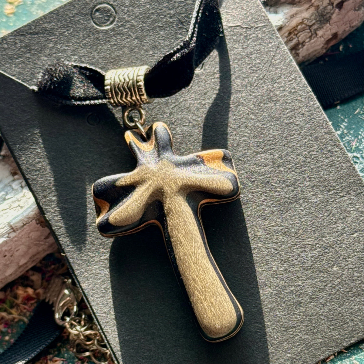 Black and natural maple cross pendant from a recycled skateboard on a black velvet choker ribbon.