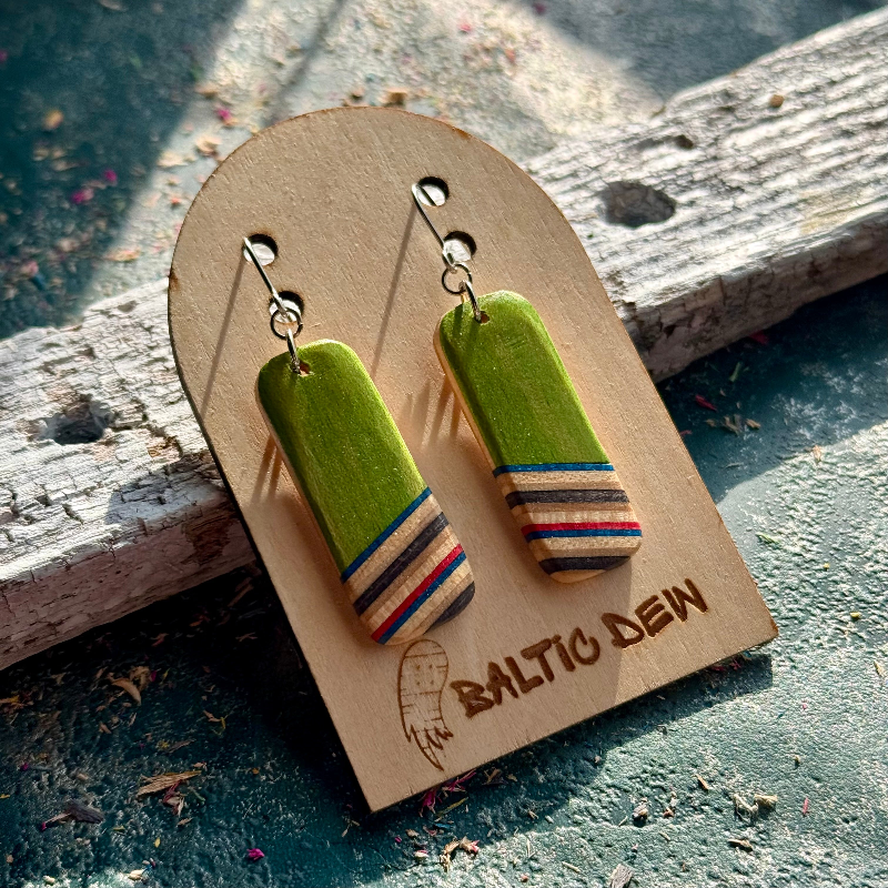Green recycled skateboard rectangle drop earrings displayed on a Baltic Dew wooden earring card.