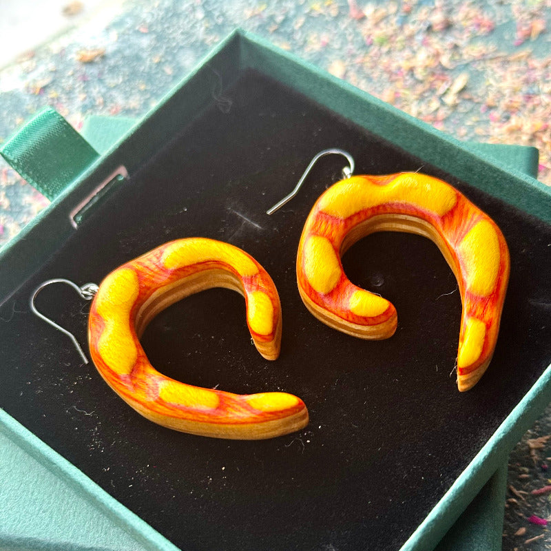 Pair of snake-shaped earrings in a box
