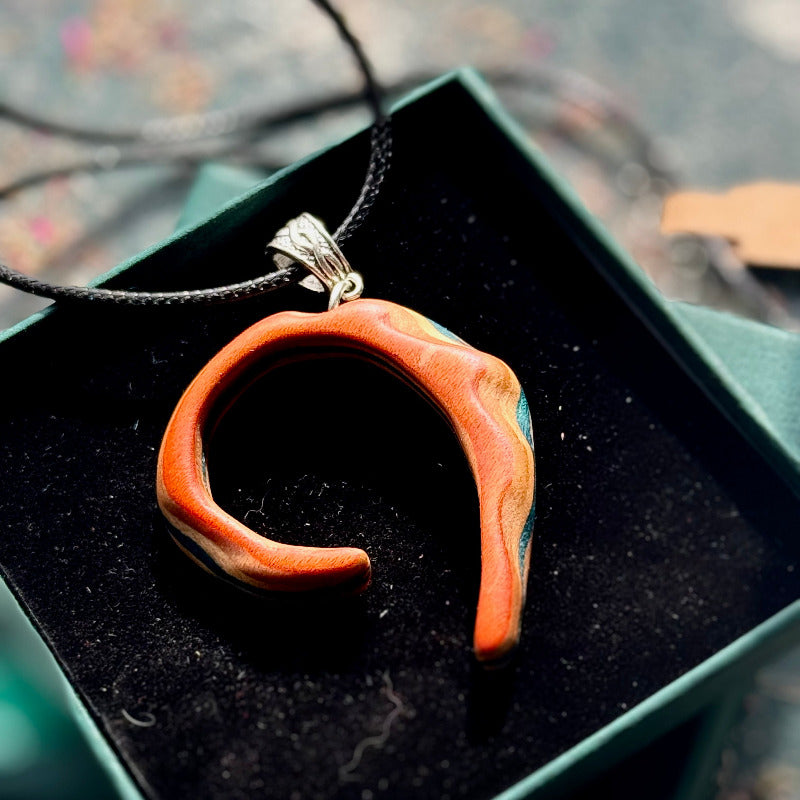 Wooden pendant necklace on a black background
