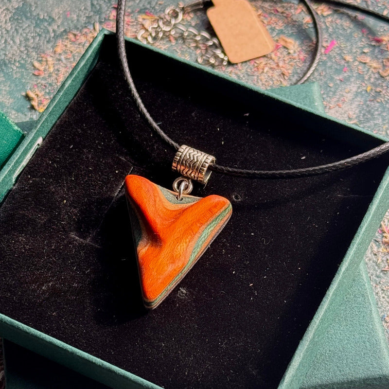 Necklace with a wooden pendant in a green jewelry box