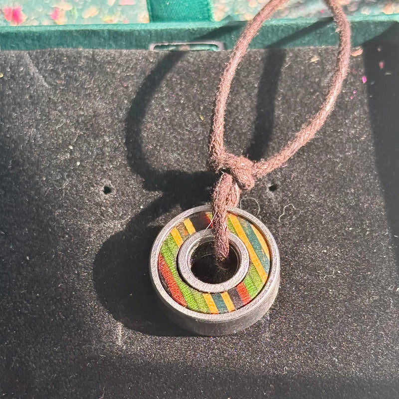 Necklace with a colorful pendant on a textured surface