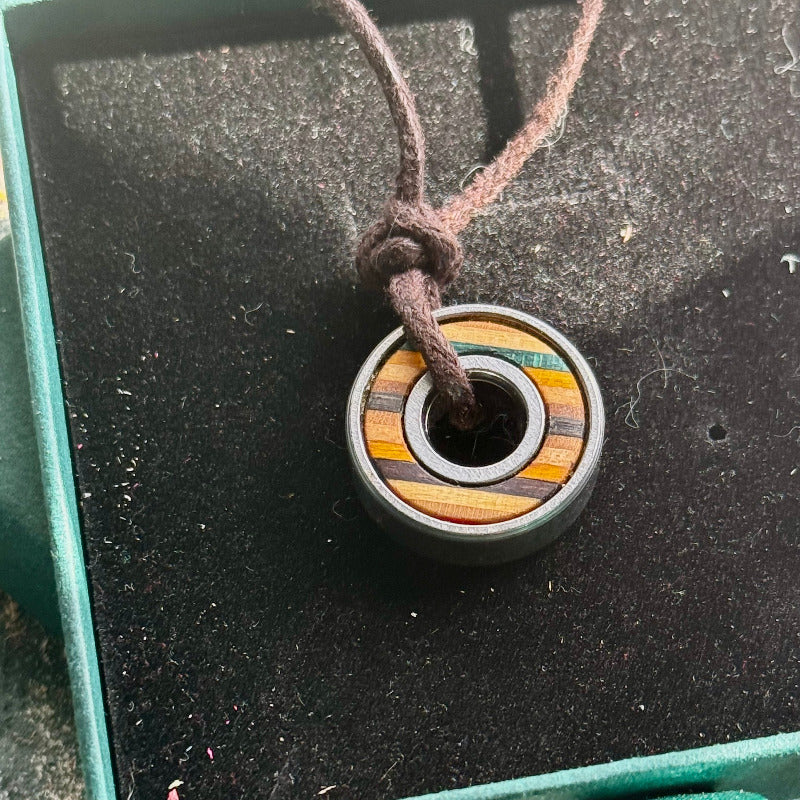 Necklace with a colorful pendant on a textured surface