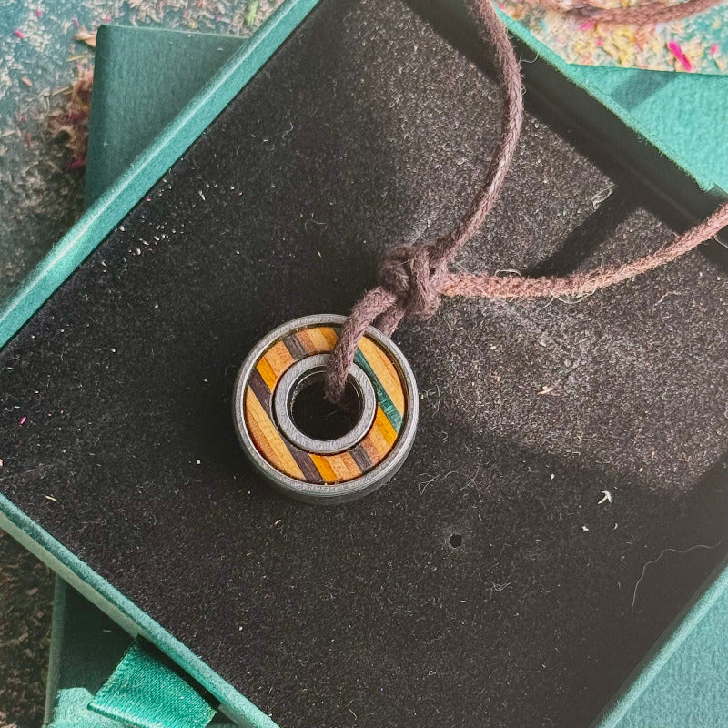 Necklace with a wooden pendant on a black display box