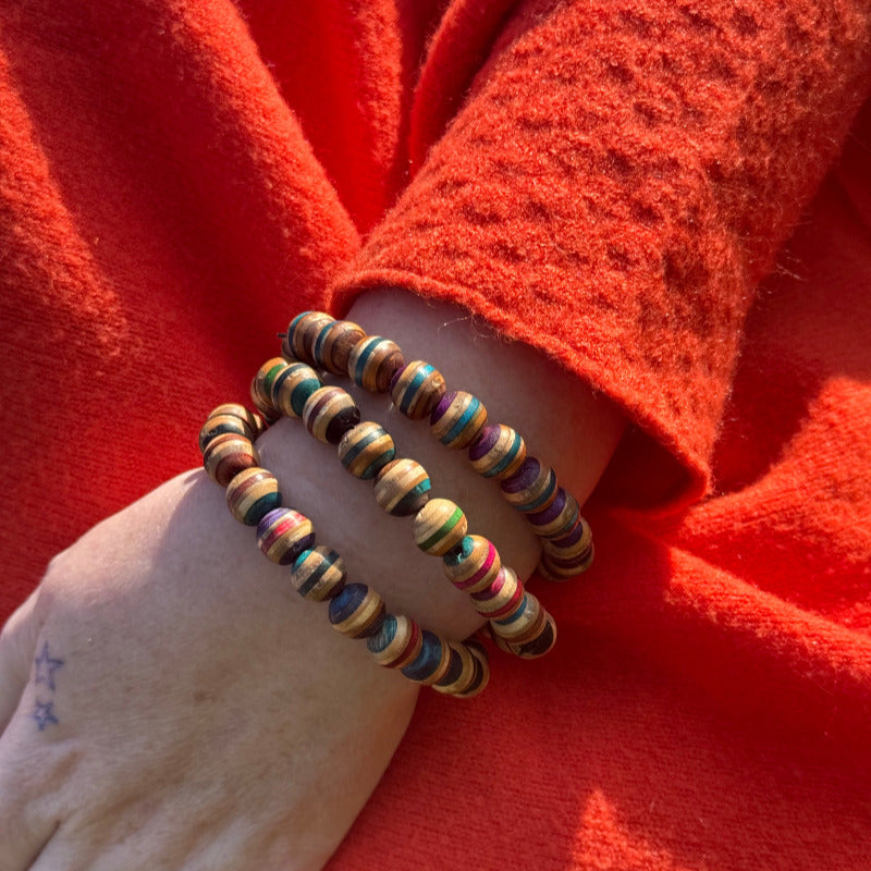 A brown and grey bracelet made from recycled skateboard wood with oiled wooden finish, handmade by Baltic Dew