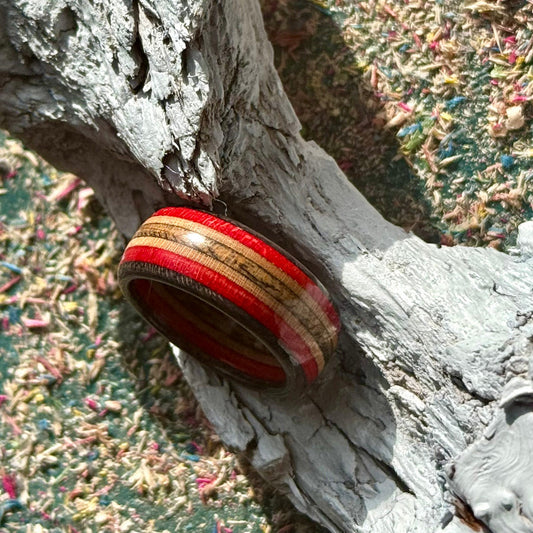 A multicolour layered ring made from recycled skateboard wood with glossy CA glue finish, handmade by Baltic Dew