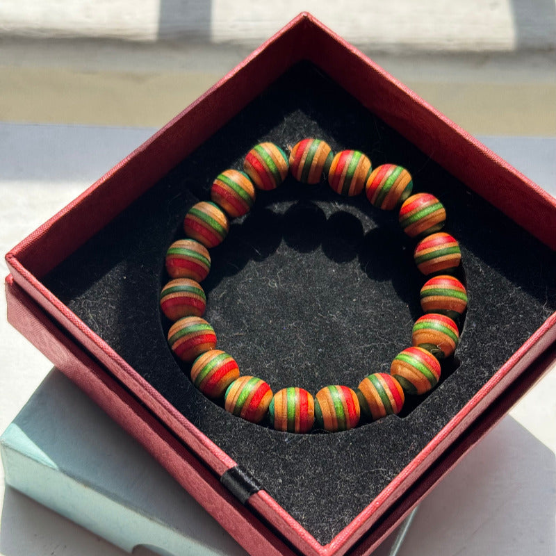 Handmade recycled skateboard Red, Green, Teal & Orange Striped Bead Bracelet — Baltic Dew, made in the UK