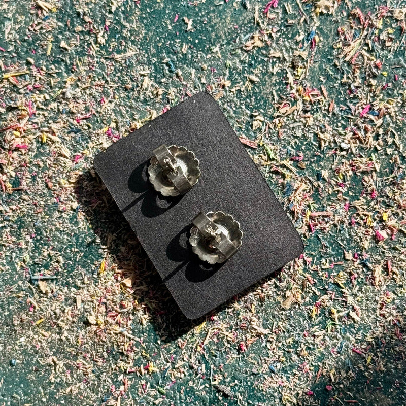 Back view of wooden stud earrings with stainless steel posts and butterfly backs.