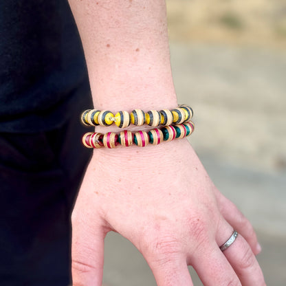 Pink and green recycled skateboard wood beaded bracelet worn on the wrist