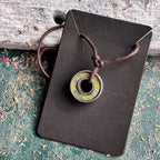 Skateboard bearing pendant necklace in green and blue recycled skateboard maple, handmade by Baltic Dew.