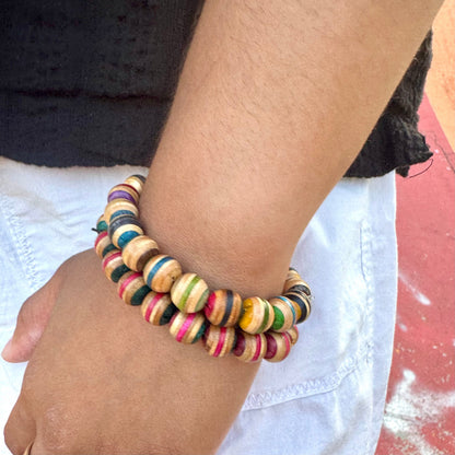 Recycled skateboard wood bead bracelets worn on the wrist at a skatepark, showing how the range is worn.