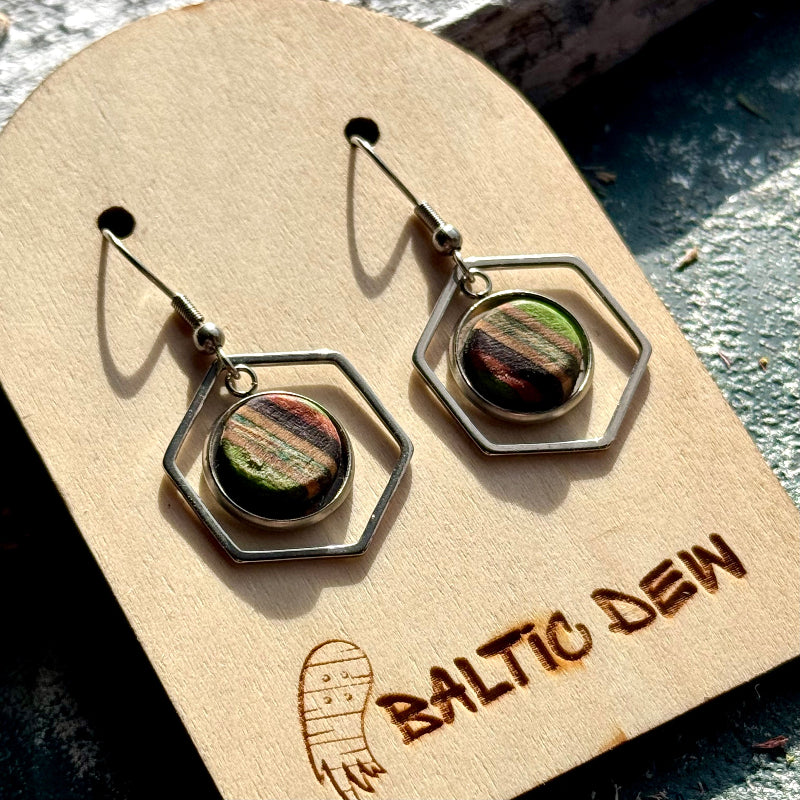 Lightweight geometric earrings with multicoloured layered maple centres in open hexagon frames.