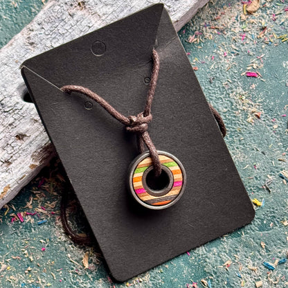 Multicoloured skateboard bearing pendant necklace in recycled skateboard maple, handmade by Baltic Dew.