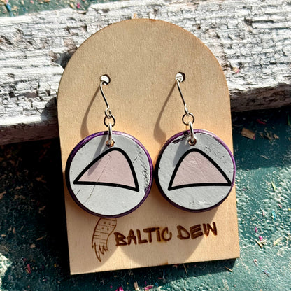 Round white and pink cat ear skateboard wood earrings on surgical steel hooks, shown on a card