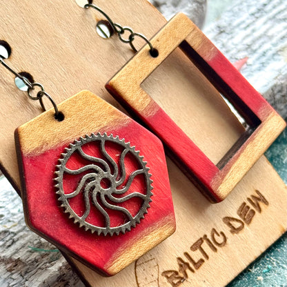 Close view of a red skateboard wood hexagon earring with a decorative spiral cog