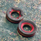 Dark grey tunnels with a red inner edge, cut from the darker layers of a recycled deck.