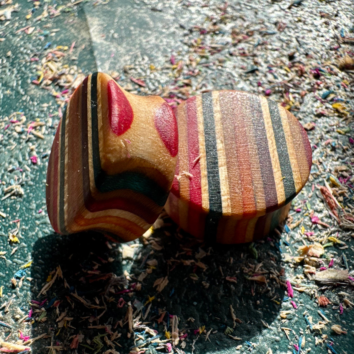 Skateboard wood plugs shown face on and from the side, the double flare waist visible.