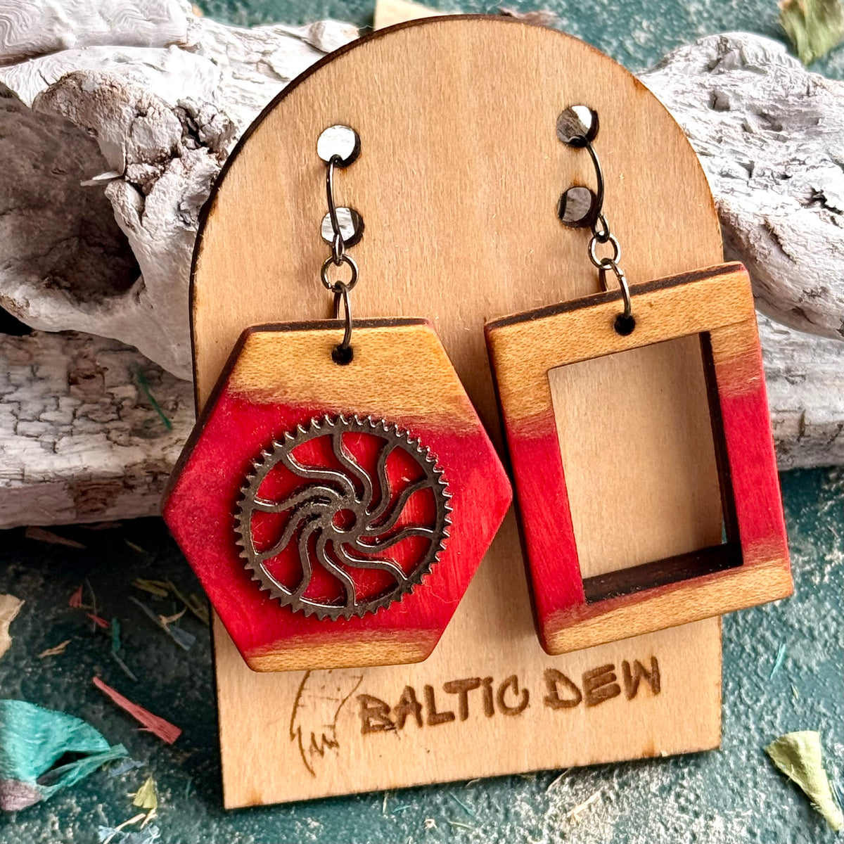 Red hexagon with a spiral cog paired with an open rectangle frame, skateboard wood earrings