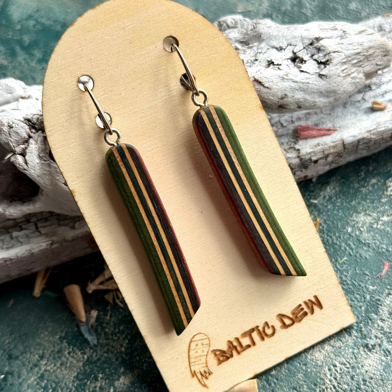 Green recycled skateboard long drop earrings with cream and dark stripes, on a Baltic Dew card