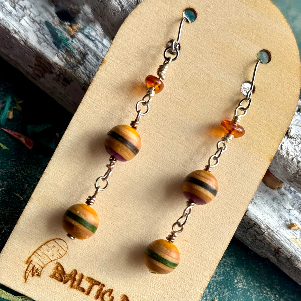 Close view of the Lithuanian Baltic amber at the top of a recycled skateboard wood drop earring