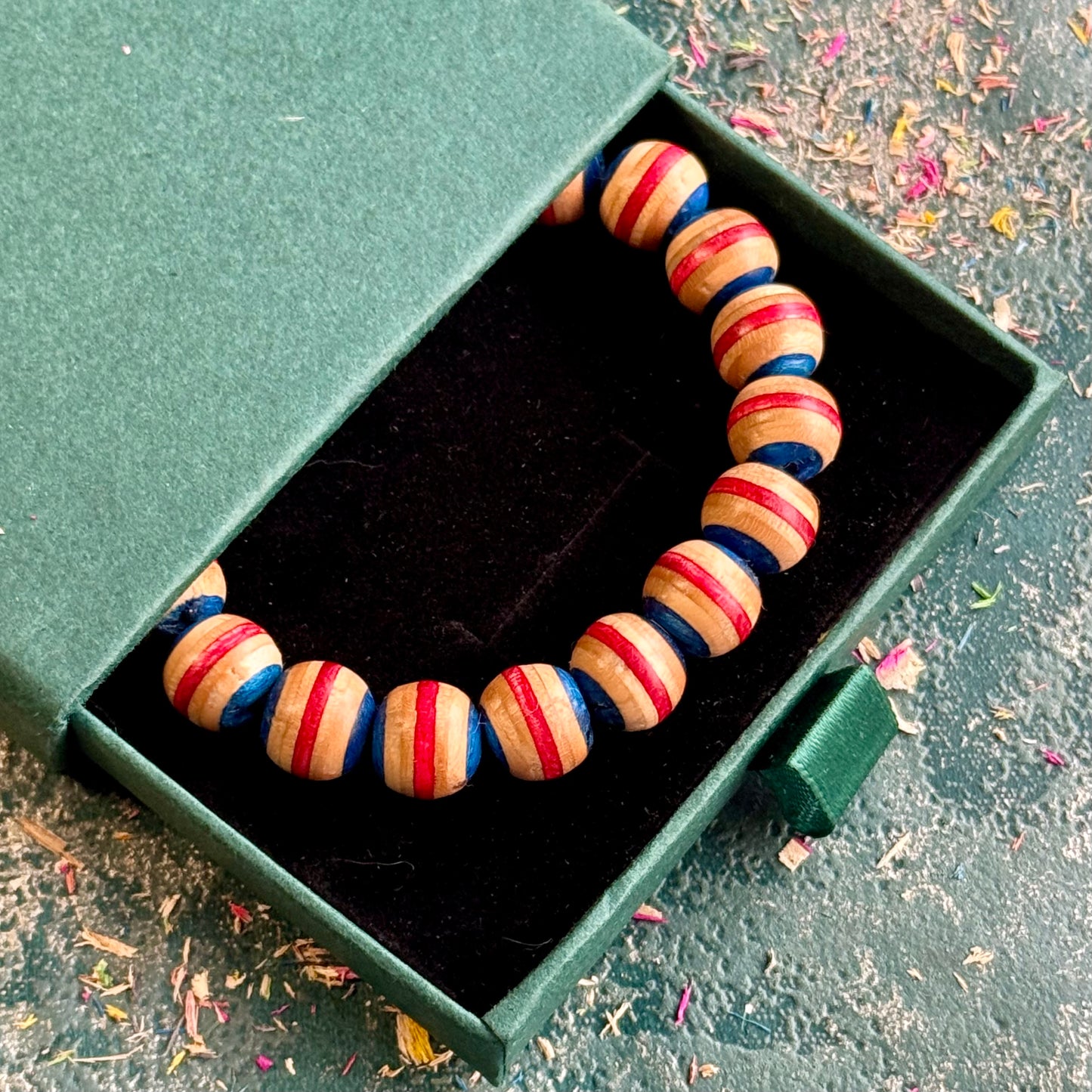 Blue and red recycled skateboard wood beaded bracelet in a Baltic Dew gift box