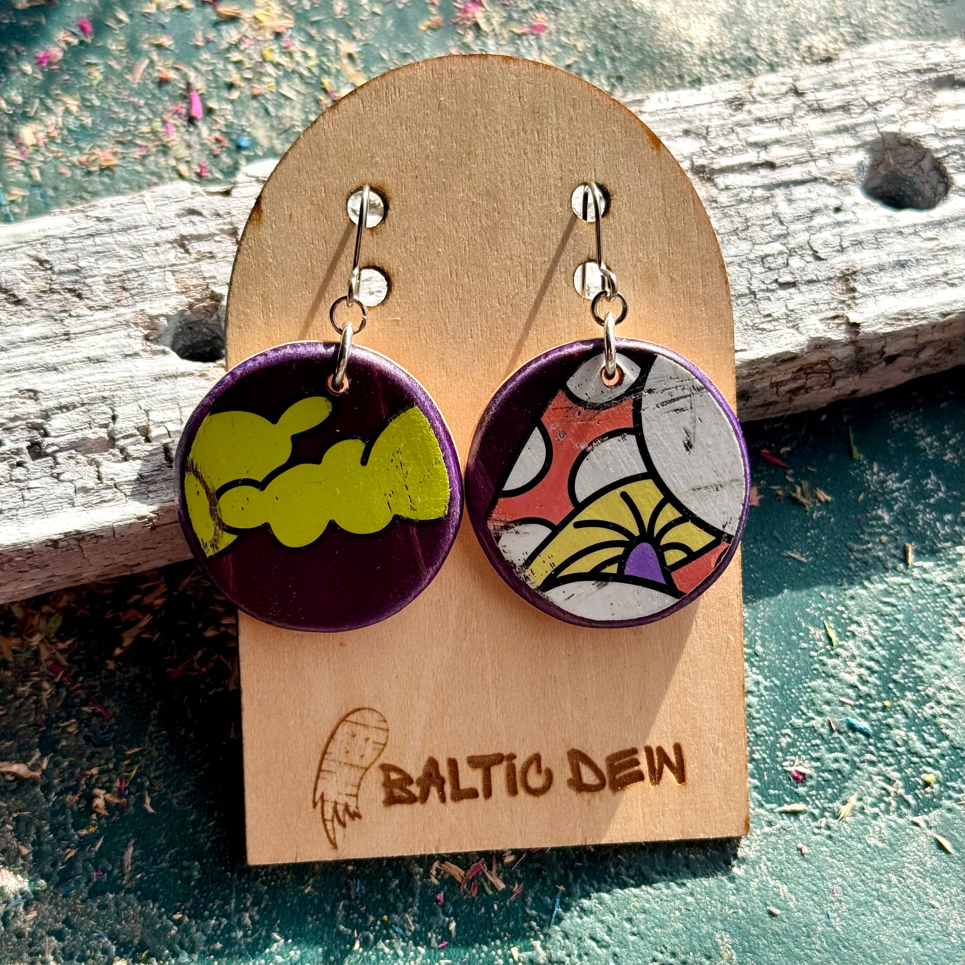 Purple and green skateboard wood earrings showing mushroom and cloud fragments of the deck artwork