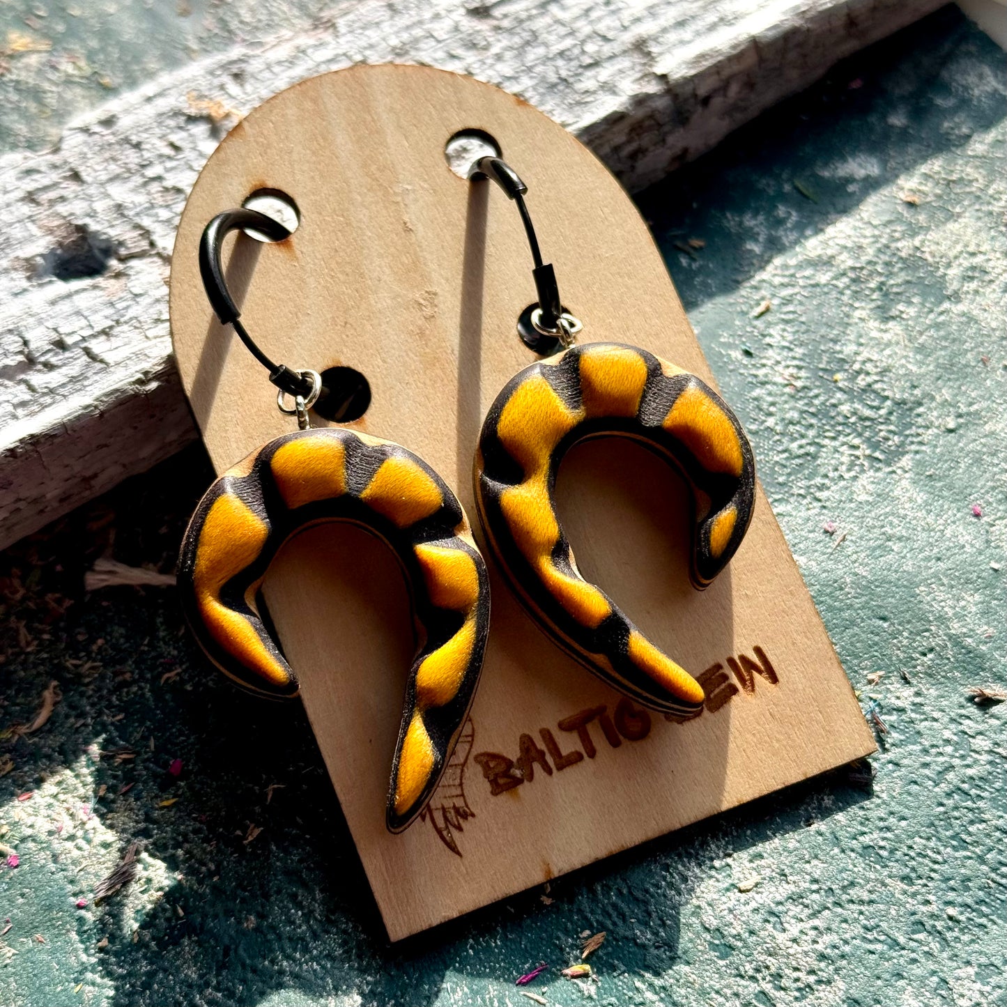 Yellow and black recycled skateboard wood spiral earrings on 25mm black stainless steel hoops