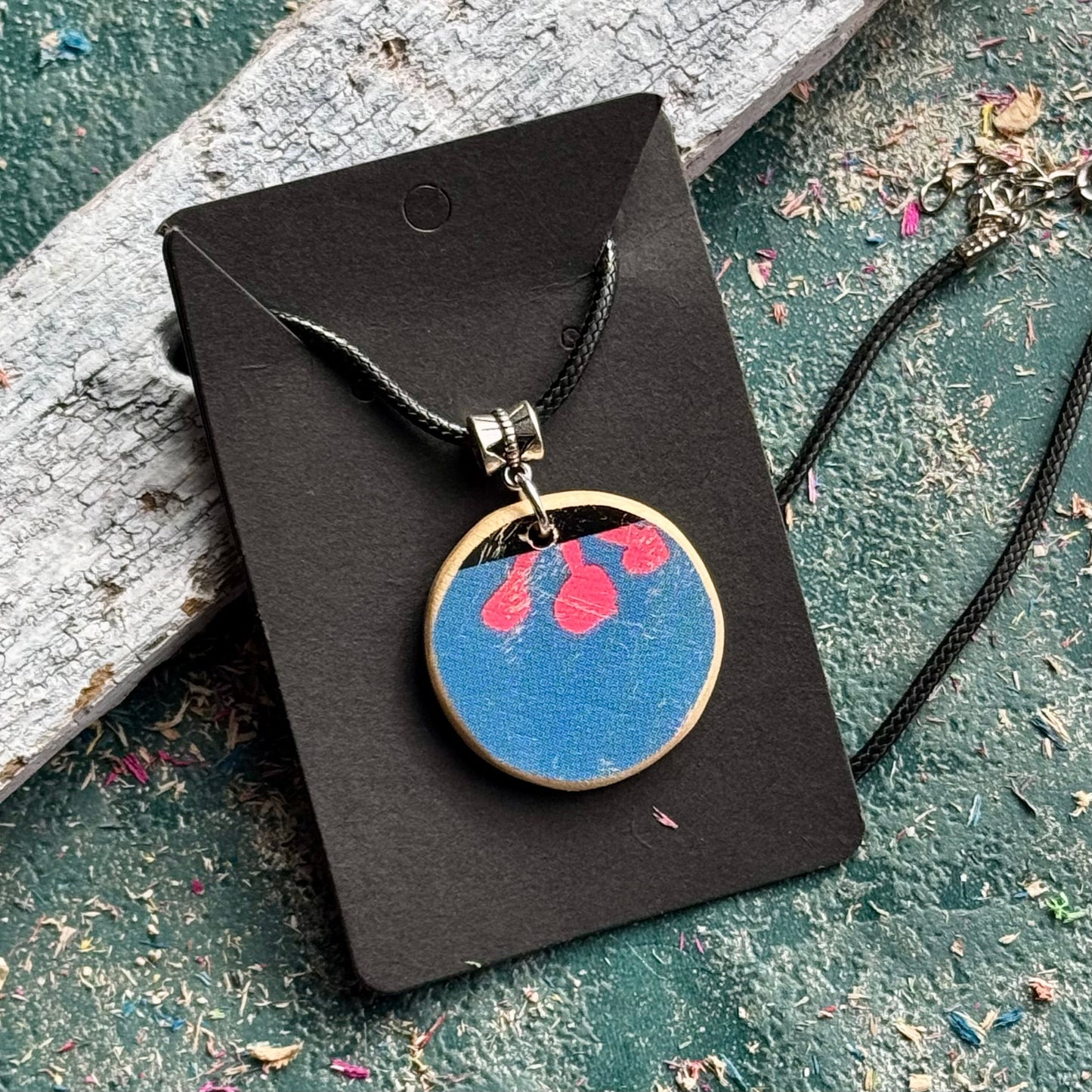 Blue and pink flower pendant cut from a recycled skateboard deck, handmade by Baltic Dew.