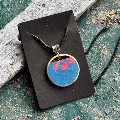 Blue and pink flower pendant cut from a recycled skateboard deck, handmade by Baltic Dew.