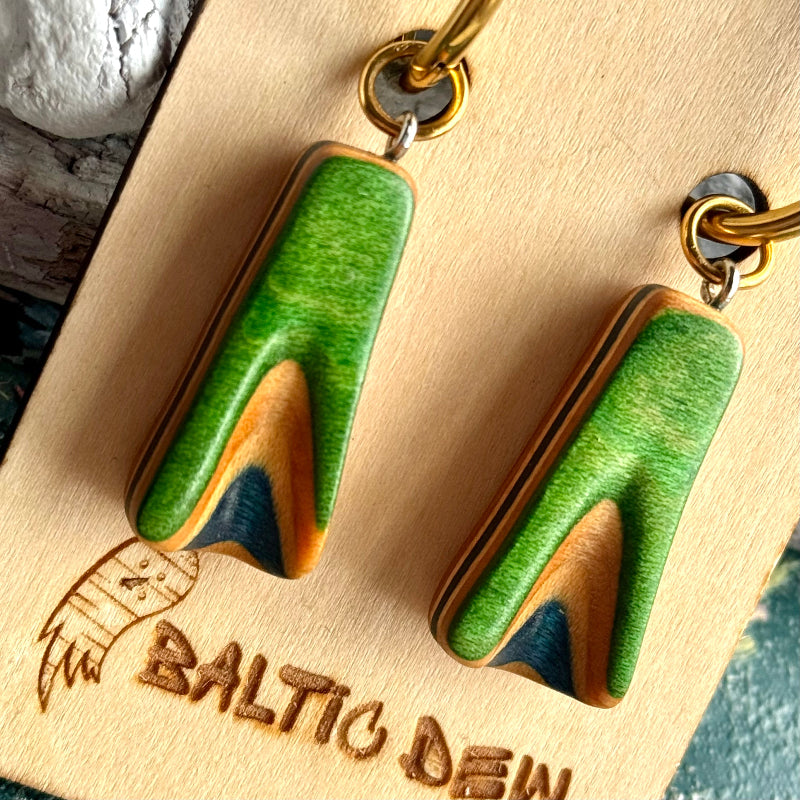 Bright green skateboard wood hoop drops on gold hoops, with maple and dark blue layers in the carved tip