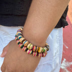 Recycled skateboard wood beaded bracelet worn on the wrist, striped maple beads in mixed colours