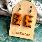 Bright orange carved skateboard wood earrings with dark purple waves through the layers