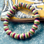Pink and green recycled skateboard wood bead bracelet, with pink, green and dark blue layers on every bead.