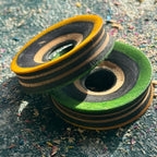 Yellow and green faced skateboard wood tunnels with black and natural maple layers.