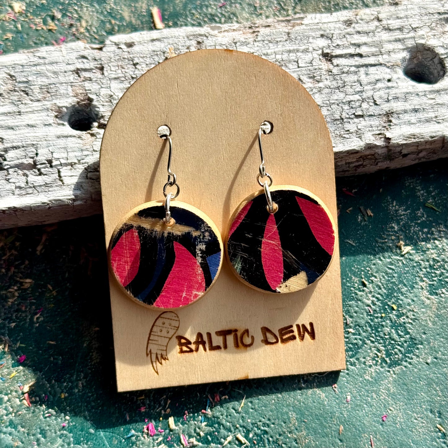 Pink and black round recycled skateboard wood earrings on surgical steel hooks, handmade by Baltic Dew