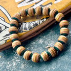Light teal and yellow recycled skateboard wood bead bracelet, handmade by Baltic Dew.