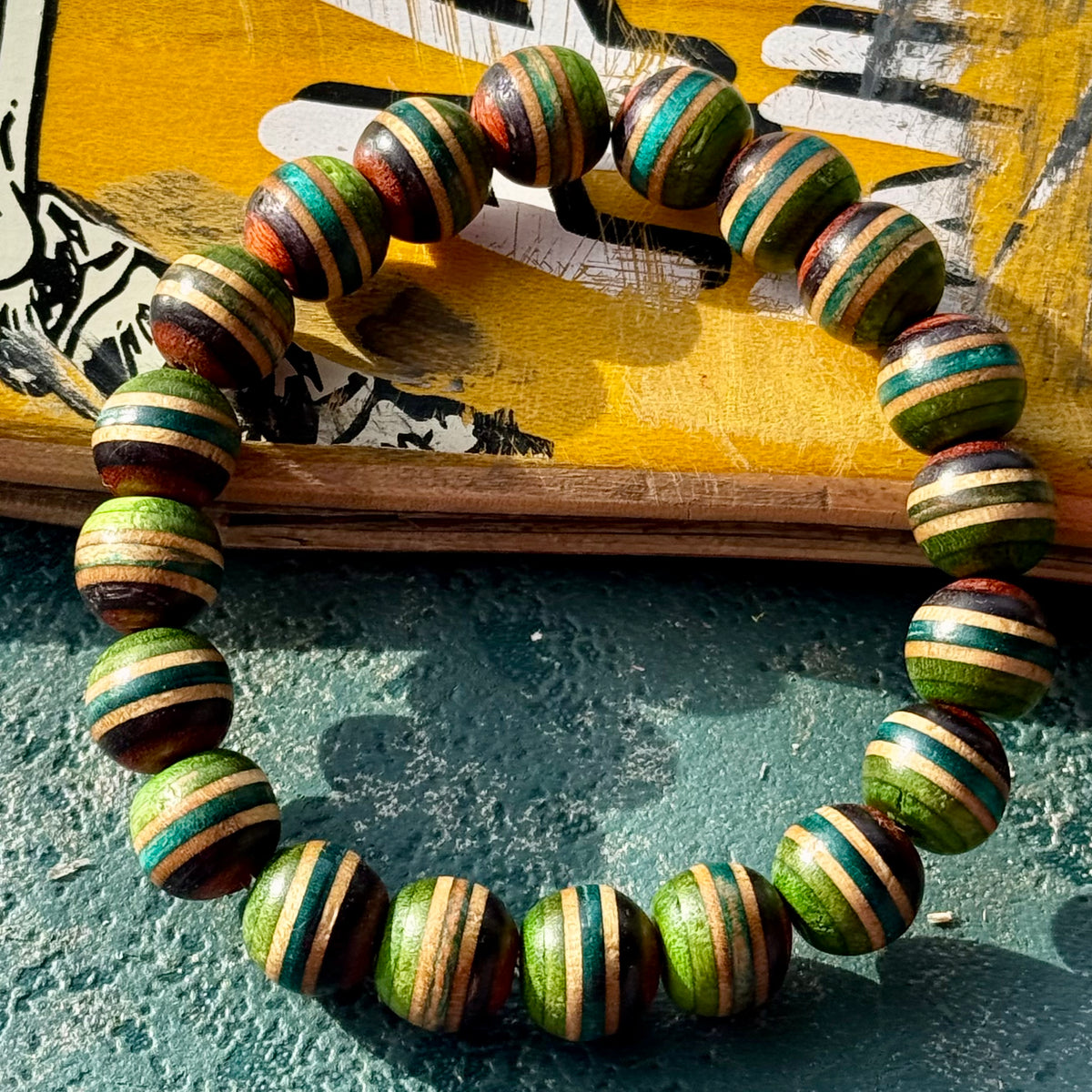 Green, teal and brown skateboard maple beads strung on elastic, handcut and sanded by Baltic Dew.