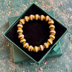 Yellow and black recycled skateboard wood beaded bracelet in a Baltic Dew gift box