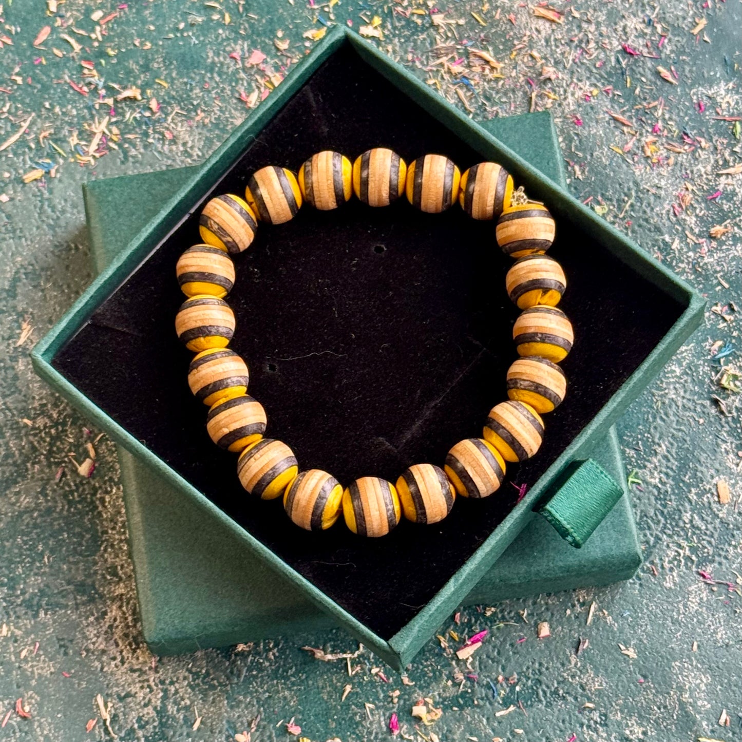Yellow and black recycled skateboard wood beaded bracelet in a Baltic Dew gift box