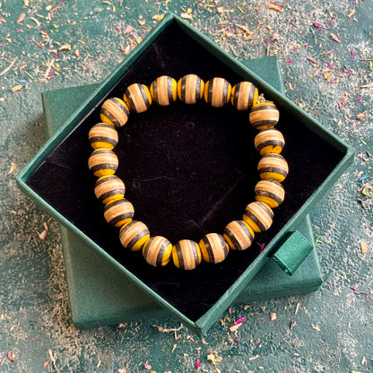 Yellow and black recycled skateboard wood beaded bracelet in a Baltic Dew gift box