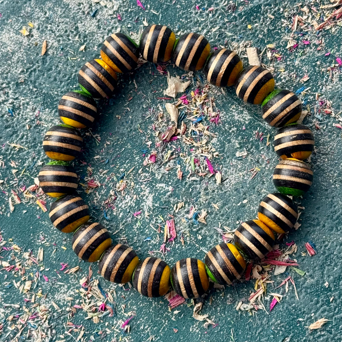 Black, yellow and green recycled skateboard maple bracelet on elastic stretch cord.
