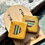 Yellow recycled skateboard square drop earrings with heart cut-outs, showing green, teal and cream layered maple.