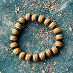 Recycled skateboard maple bracelet in light teal and yellow, handcut and sanded by Baltic Dew.