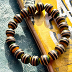 Twenty black, yellow and green striped beads cut from recycled skateboard maple, handmade by Baltic Dew.
