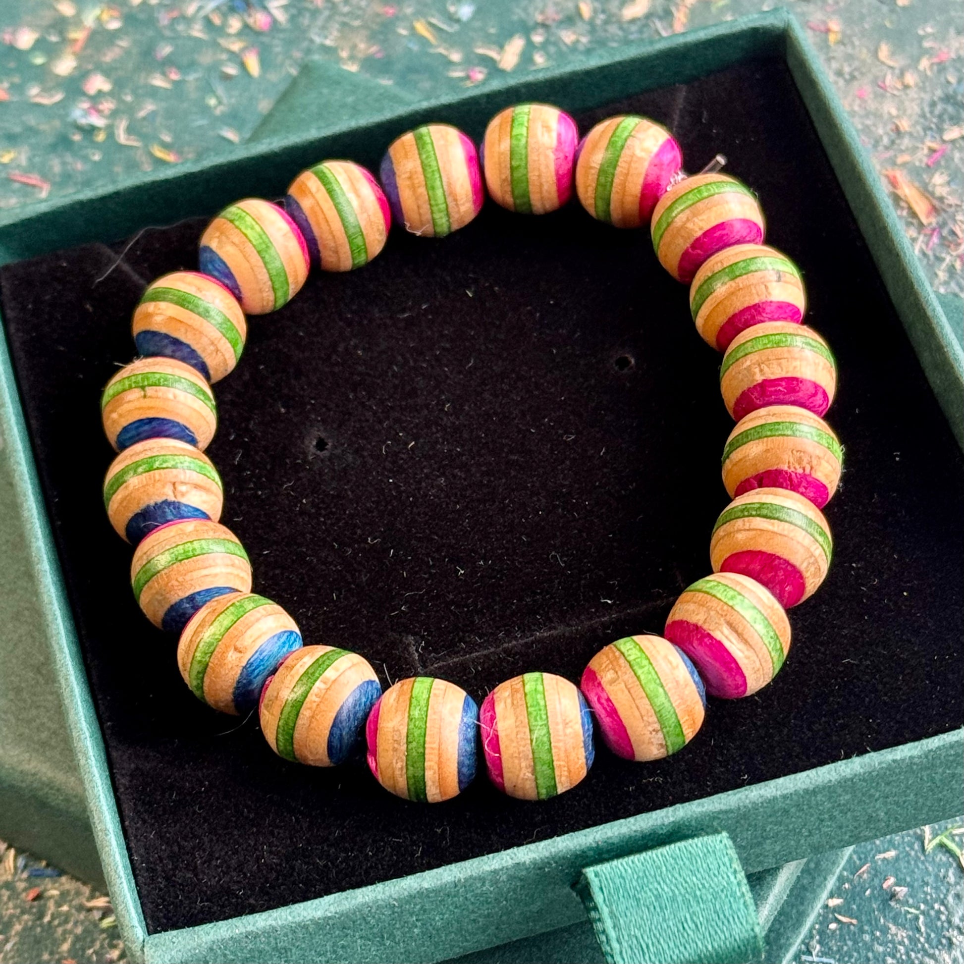 Pink and green recycled skateboard wood beaded bracelet in a Baltic Dew gift box