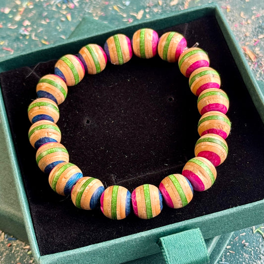 Pink and green recycled skateboard wood beaded bracelet in a Baltic Dew gift box