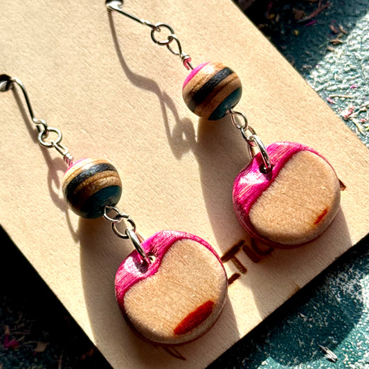 Recycled skateboard wood bead drop earrings with a striped bead above a pale maple disc