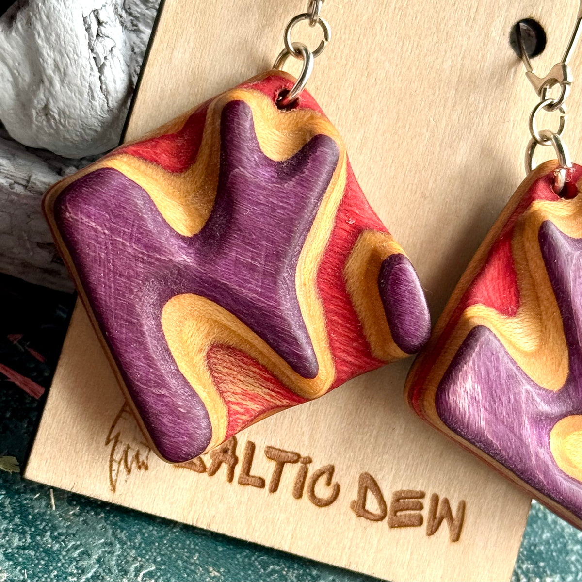 Large square carved earrings cut from a recycled skateboard deck, handmade by Baltic Dew