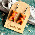 Carved skateboard wood wave earrings in orange, red and green with a sharp zigzag through the layers