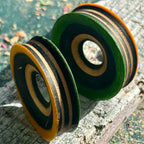 Yellow and green tunnels with concentric black and maple rings around the opening.
